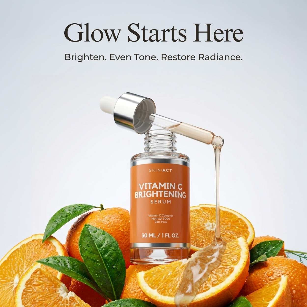 Vitamin C brightening serum with oranges and dropper on a light gray background